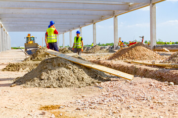Pile of sand and wooden plank at building site