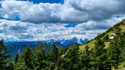 Panoramic view in spring from Frauenkogel on mountain peaks in the Karawanks and Julian Alps, Carinthia, Austria. Border with Slovenia. Triglav National Park. Jesenice in the Upper Drava valley. Hike