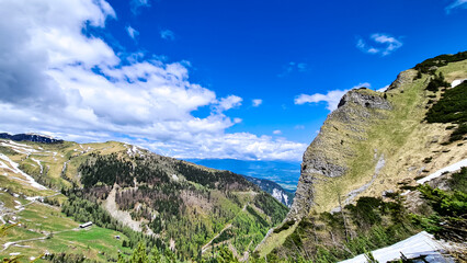 Naklejka premium Mountain peak of Hahnkogel (Klek) with panoramic view in spring in the Karawanks, Carinthia, Austria. Borders Austria, Slovenia, Italy. Triglav National Park. Alpine meadows. Alm. Snow fields melting
