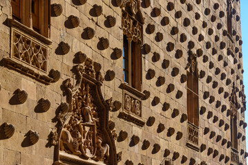 Fototapeta na wymiar Casa de Las Conchas or House of the Shells was built in the late Gothic civil style or Plateresque. It is located in the old city of Salamanca that was declared a UNESCO World Heritage site. Castile a