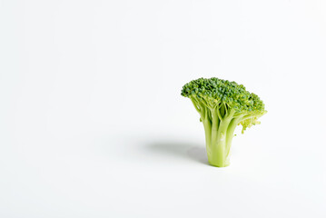Close up shot of a sliced broccoli on a white background.