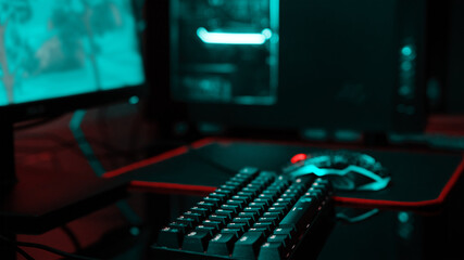 PC with rgb keyboard for gaming computer video games with neon colored background, dark room with...