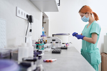 Naklejka na ściany i meble Doctor working with medical equipment in the laboratory