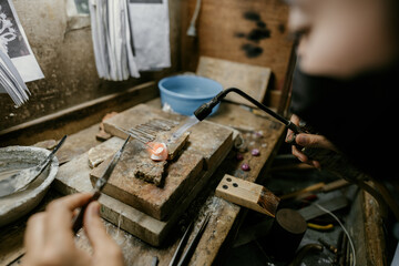 Jeweler at work in jewelry. Desktop for craft jewelry making with professional tools. Close up view of tools. Silver jewelry. 