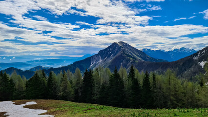 Panoramic view near Frauenkogel on the mountain peaks in the Karawanks, Carinthia, Austria. Borders Austria, Slovenia, Italy. Triglav National Park. Looking on mount Kahlkogel (Golica). Forest valley