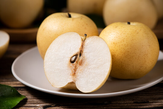 Chinese pear with cut in half on wooden table. 