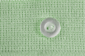 Button sewn on knit background