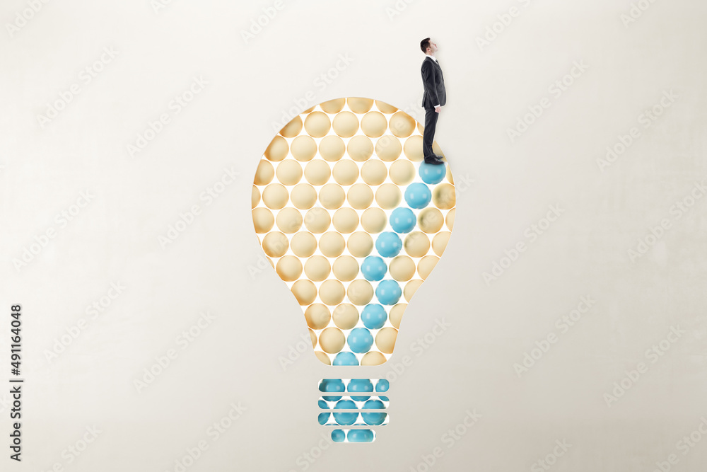 Poster European businessman in suit standing on abstract pattern light bulb on light background with mock up place. Idea, growth and success concept.