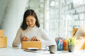 Online seller owner. Online shopping. Business Start up SME concept. Young startup entrepreneur small business owner working at home, packaging and delivery situation.