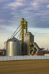 Obraz premium agro silos granary elevator. Silos on agro-processing manufacturing plant for processing drying cleaning and storage of agricultural products, flour, cereals and grain.