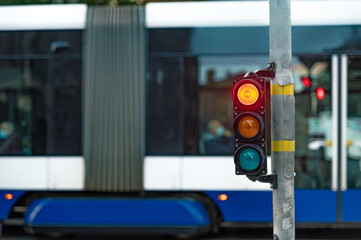view of city traffic with traffic lights, in the foreground a traffic light with a red light