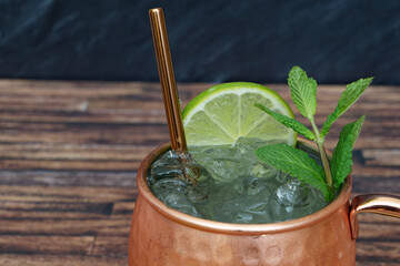 Delicious London mule cocktail in copper cup with fruit.