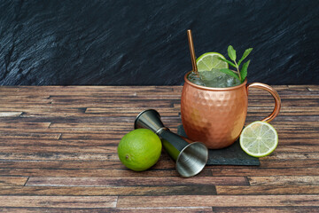 Delicious London mule cocktail in copper cup with fruit.