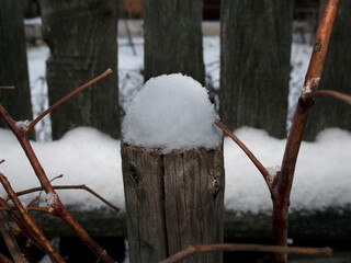 Snow sticking to a wooden object, a small snowdrift