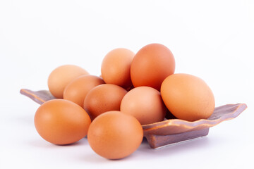 chicken eggs lies in a japaness ceramic saucer on white background.