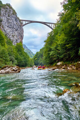 Rafting in Montenegro on the Tara River with a view of the Dzhurdzhevich Bridge