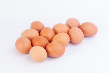 Several chicken eggs are placed on a white background...