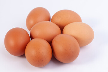 seven eggs are placed on a white background with free space on right