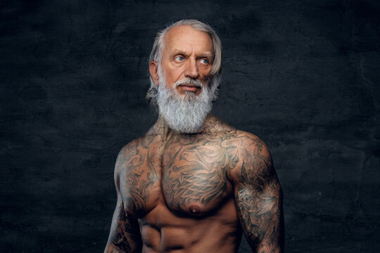 Fitnes grandfather bodybuilder with long beard and naked torso