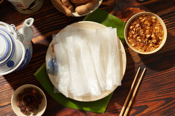 Rice paper roll decorated in wooden table with tamarind sauce and flower pot for food advertising 