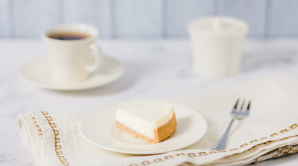 A Simple Slice Of New York Cheesecake With Blueberries On A White Table Background. A Delicious Piece Of Cream Cake