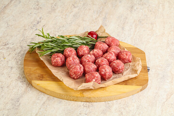 Raw uncooked beef meatballs served rosemary