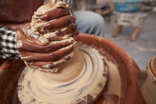 Skilled Craft Artist Throwing Pottery In His Studio