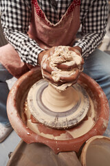 Skilled African American potter shaping ceramic ware