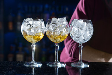 line of yellow refreshing cocktails on a bar desk