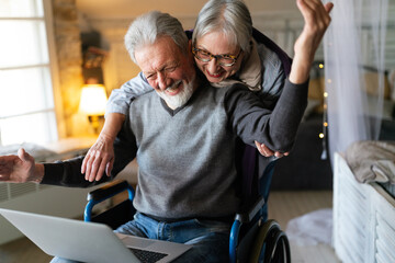 Happy romantic senior couple hugging and enjoying retirement at home