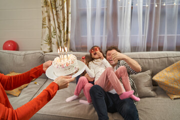 Naklejka premium Family celebrating birthday of girl and having fun