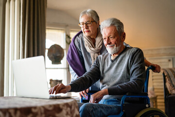 Loving older couple in a nursing home together. Senior people technology concept