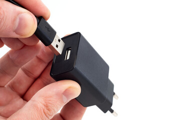 The man's hands hold the USB cable to connect to the adapter. USB cable on white background