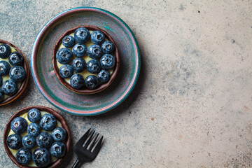 Tartlet with blueberries, chocolate and cream cheese.