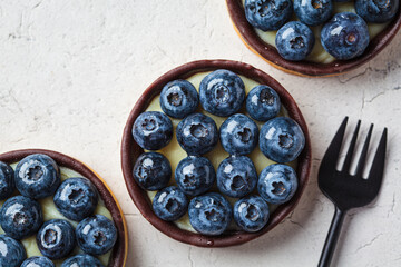 Tartlet with blueberries, chocolate and cream cheese.