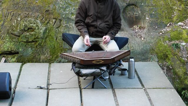 A street musician plays cymbals. Next to it stands a thermos and a speaker. Musical instrument in retro style