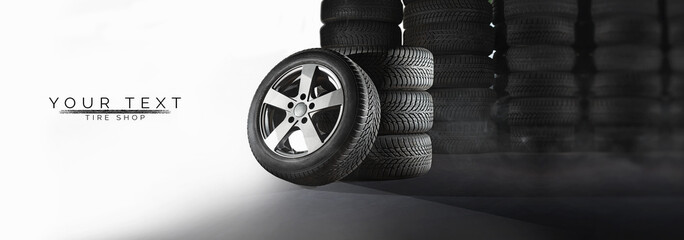 Tire shop, auto service and car wheel tyre store design. Pile of automobile black rubber tires...