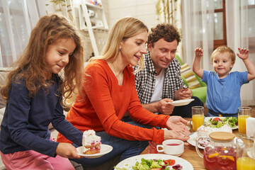 Parents with daughter and son eating at home