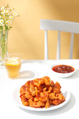 A front view of cripsy pork crackling decorated in white and orange background for food advertising