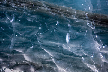 Natural ice texture with stone or rocks inclusions in an alpine glacier