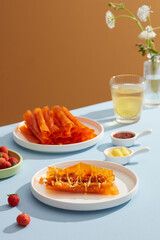 rice paper roll decorated strawberry tamarind sauce and butter in white dish and blue background for food advertising 
