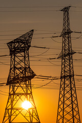 High voltage pylons at sunset. 