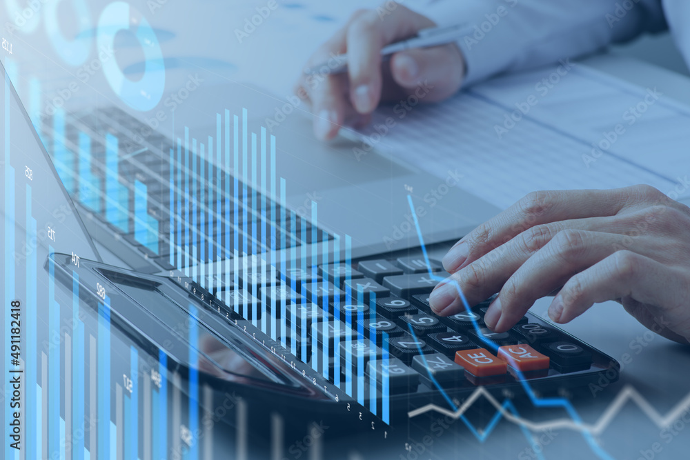 Poster Analyzing financial data. Working with calculator. Many graphs and charts.  Laptop and reports on desk.