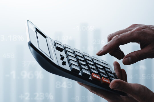 Calculating costs and benefits. Working with calculator. Graph and number. Close up of hands.