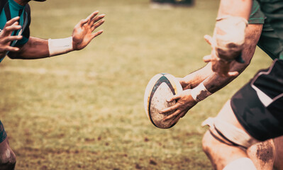 rugby player preparing to kick the oval ball during game