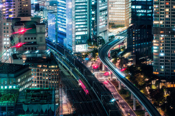 Fototapeta na wymiar Several sky train passing through illuminated building in business district at Tokyo, Japan