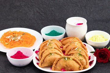 Indian Mithai Gujia Also Called Gujiya, Pirukiya, Pirukia, Pedakiya, Karanji, Basundi Gughra Made Of Suji Ghee Stuffed With Mawa Khoya Chasni Mava And Khoa With Holi Color Gulal Abir Abeer And Thandai