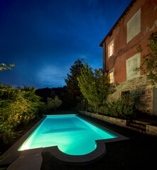 Villa with beautiful garden and illuminated swimming pool in Tuscany.