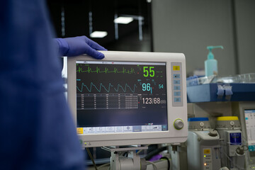 Doctor checking heartbeat and vital sign on monitor