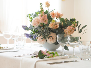 Wedding table setting with flowers. Table setting with pastel color flowers.